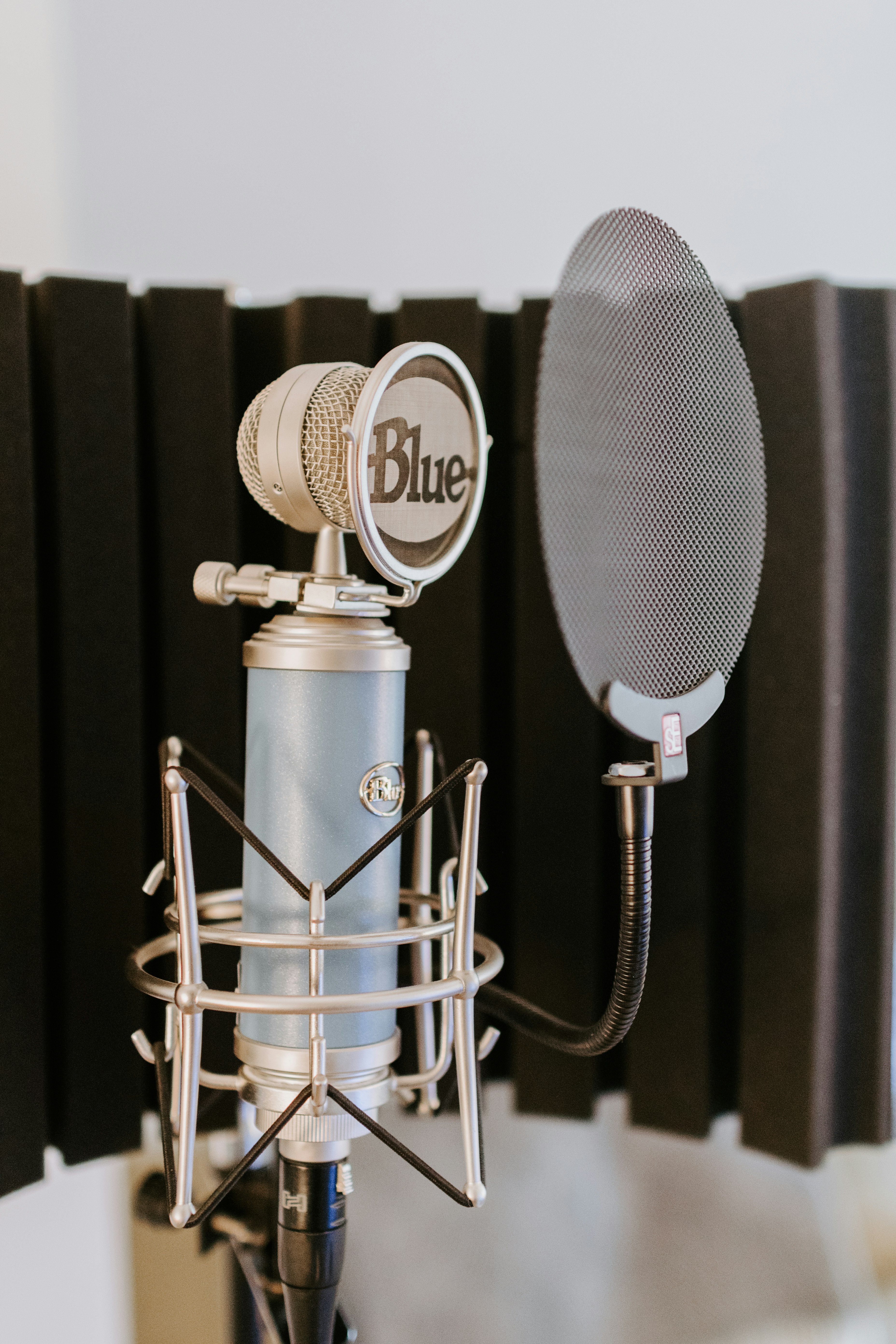 silver and black microphone on black and silver microphone stand